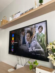 telewizor z płaskim ekranem siedzący na ścianie w obiekcie Shanin's Homestay w mieście Kuala Terengganu