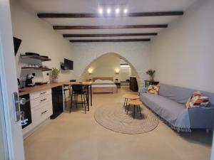 a kitchen and living room with a couch and a table at Coucou Boutique Studio in Ios Chora