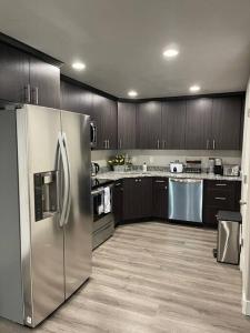 a kitchen with stainless steel appliances and wooden cabinets at Exotic Basement apartment, fully furnished in Provo