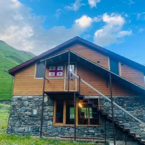 a log cabin with a large window on the side of it at Hotel Arkhoti in Akhieli
