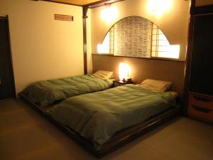 Кровать или кровати в номере Inatori Tokai Hotel Yuen
