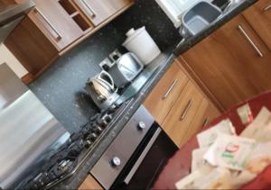 an overhead view of a kitchen with a stove top oven at Neveah in Routh