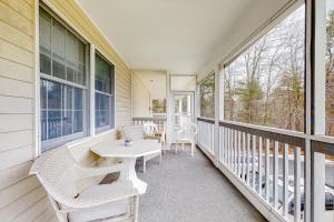 a porch with a table and chairs and windows at Wellington Manor 240 in Wells