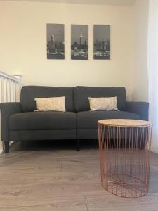 ein Wohnzimmer mit einem Sofa und einem Tisch in der Unterkunft New modern 1 bedroom duplex apartment Hemel Hempstead High Street in Hemel Hempstead