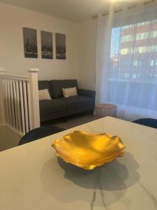 a yellow sculpture sitting on a table in a living room at New modern 1 bedroom duplex apartment Hemel Hempstead High Street in Hemel Hempstead