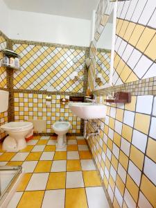 a bathroom with a sink and a toilet at Casa di Agnese in Alghero