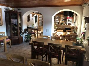 a restaurant with a large wooden table and chairs at Relax 38 in Prievidza