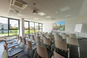 a lecture room with chairs and a white wall at Hôtel Restaurant Athena Spa in Strasbourg +75 photos