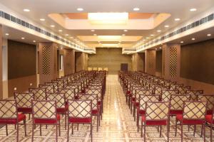 an empty hall with rows of chairs in a room at Hotel Kana in Jodhpur