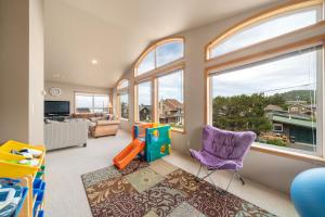a childrens room with a play room with windows at Sandpiper Beach House in Cannon Beach