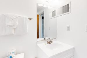 a white bathroom with a sink and a mirror at Town of Dewey Beach --- 6 Jersey Street in Dewey Beach +25 photos