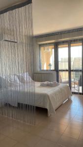 a bedroom with a large bed with a curtain at Casa Valentina 2 in Perugia
