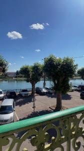 a view of a parking lot with cars parked at Appartement privé « Rive Droite » in Serrières