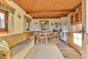 a living room with a couch and a table at Jörgishof in Untertscheltsch