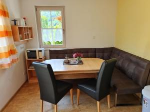 a dining room with a table and chairs and a couch at Holiday flat Aschau in Aschau