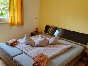 a bedroom with a bed with pillows and a window at Holiday flat Aschau in Aschau