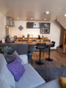 a living room with a couch and a kitchen at south view farm cottage in Bradford