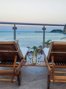 a table with two glasses and a bottle of wine at Nostalgia Apartment in Archangelos