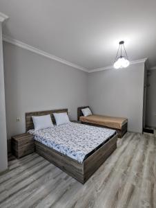 a bedroom with two beds and a chandelier at Corner house in K'obulet'i