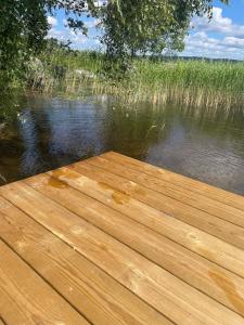 a wooden dock over a body of water at Björkudden glamping in Fristad