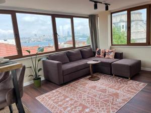 a living room with a couch and large windows at The Pillo Mansion in Istanbul