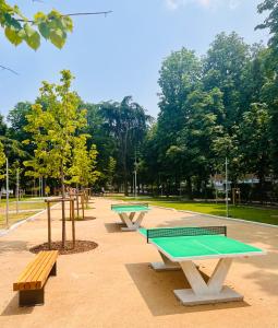 a row of picnic tables and benches in a park at Apartment Suite - Charlize - in the heart of Milan in Milan