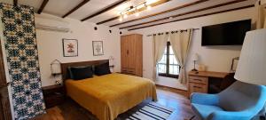 a bedroom with a bed and a desk and a chair at Villa Viara in Pchelnik