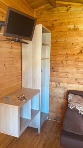 a room with a desk with a tv on a wall at Vacation Without Make Up in Šventoji