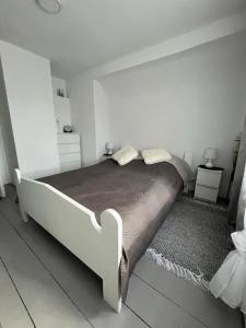 a bedroom with a large bed in a white room at Domek Mazury Pisz in Pisz