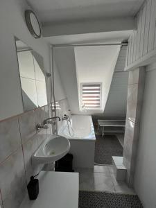 a bathroom with a sink and a mirror at Domek Mazury Pisz in Pisz
