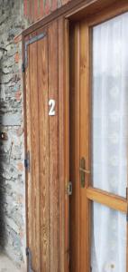 a wooden door with the number on it at Casa Quokka in Meana di Susa