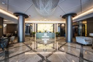 a lobby of a hotel with a chandelier at HOTEL EUROPA in Komárno