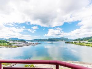 een uitzicht op een rivier vanaf een brug bij Hotel BELLMARE ホテルベルマーレ in Maizuru