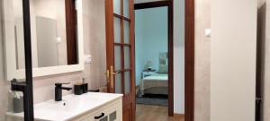 a bathroom with a sink and a mirror at casa dositeo in Sarria