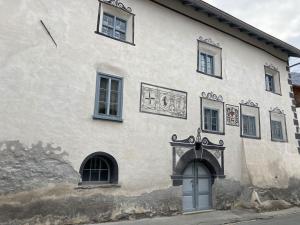 a large white building with a door and windows at Ferienwohnung Banca Veglia in Sta Maria Val Müstair