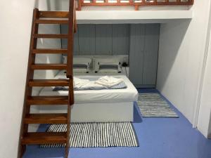 a bunk bed in a room with a ladder at the monk seal boathouse in Klima