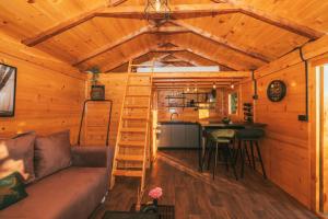a living room with a couch in a wooden cabin at Tiny house Aria in Makarska