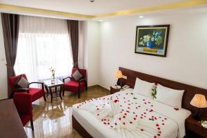 a hotel room with a bed with a flower on it at Gem Nha Trang Hotel in Nha Trang