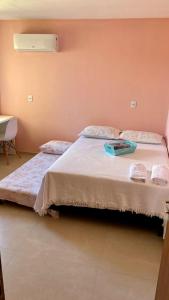 a bedroom with a bed with a tray on it at CasAMAR lençóis in Santo Amaro