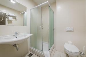 a bathroom with a shower and a sink and a toilet at Hotel & Apartments HEC Residence in Sveti Stefan