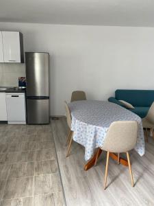 a kitchen with a table with chairs and a refrigerator at Rooms Jelena in Dubrovnik