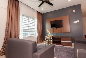 a living room with a flat screen tv on a wall at Ipoh Town P Kepayang in Ipoh