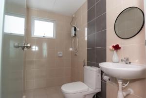 a bathroom with a toilet and a sink and a mirror at Ipoh Town P Kepayang in Ipoh +15 photos
