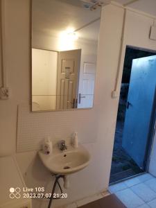 a bathroom with a sink and a mirror at Zielony Port numer 3 in Władysławowo