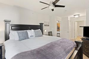 a bedroom with a large bed with a ceiling fan at First Tracks 3301 Condo in Steamboat Springs +16 photos