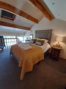 a bedroom with a large bed in a room at south view farm cottage in Bradford