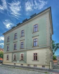 a large white building with many windows on it at Apartmány Bašta & Wellness in Sušice