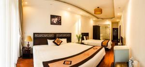 a hotel room with two beds in a room at Wild Lotus Hotel & Travel 2 in Hanoi