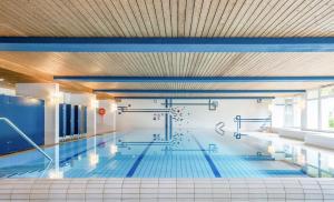 a large swimming pool in a building at Luxury Alpine Retreat with Wellness Area in Flims