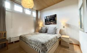 a bedroom with a bed and a large window at Luxury Alpine Retreat with Wellness Area in Flims